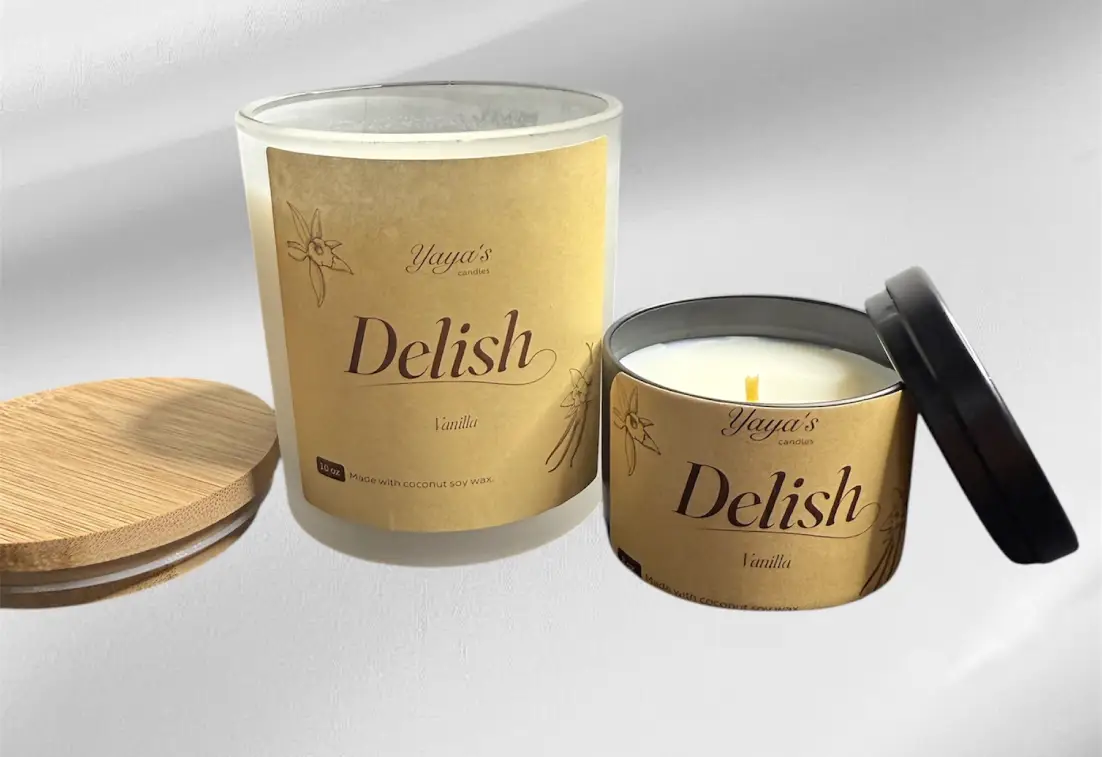 Two vanilla-scented candles from Yaya's Candles: a clear jar and a black tin, both with earthy labels and a bamboo lid.