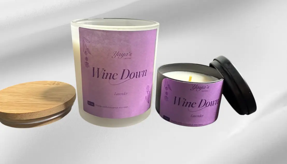 video-PT1-webp Two lavender-scented candles labeled "Wine Down" by Yaya's, one in a frosted glass jar, the other in a round black tin.